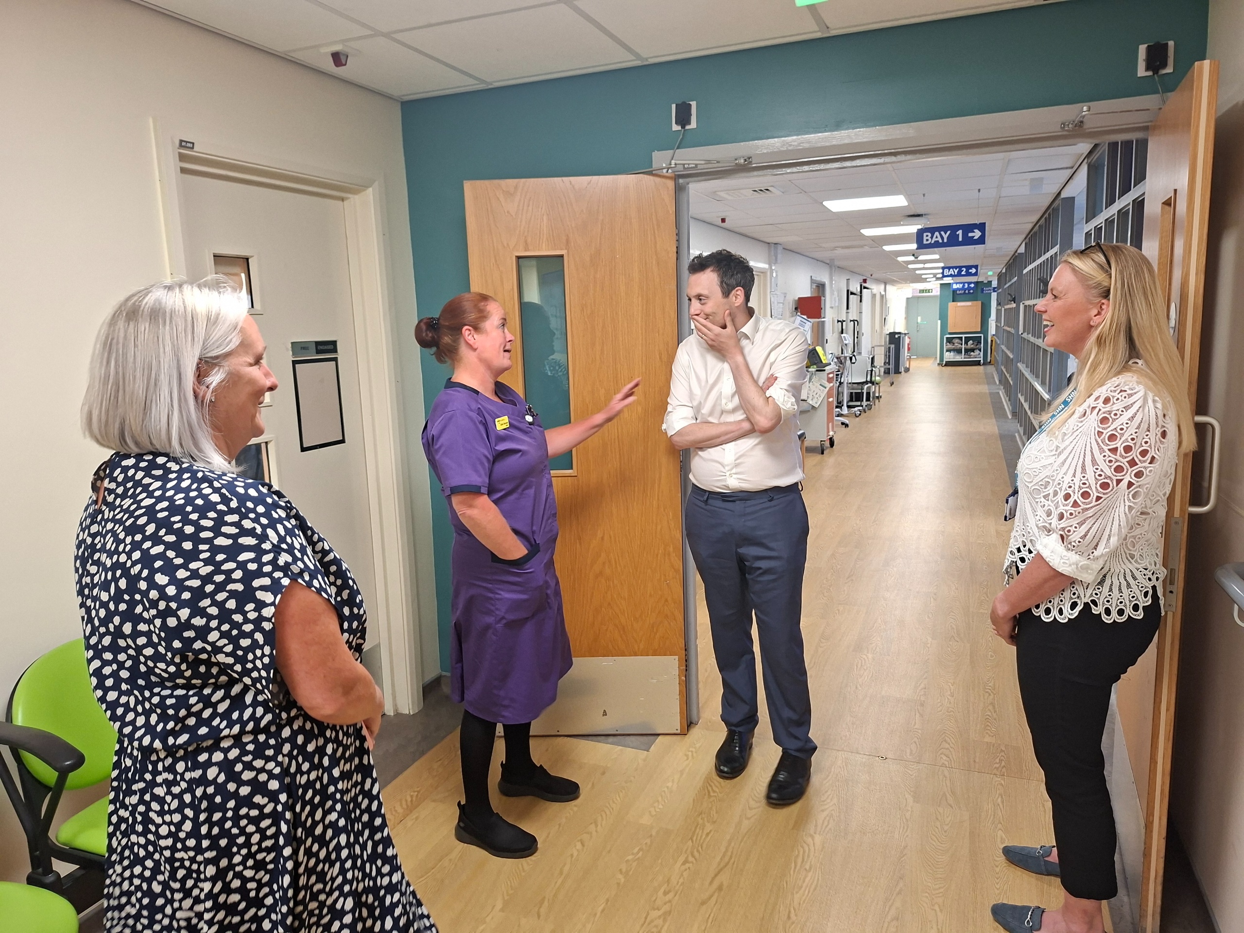 Four people on a hospital corridor