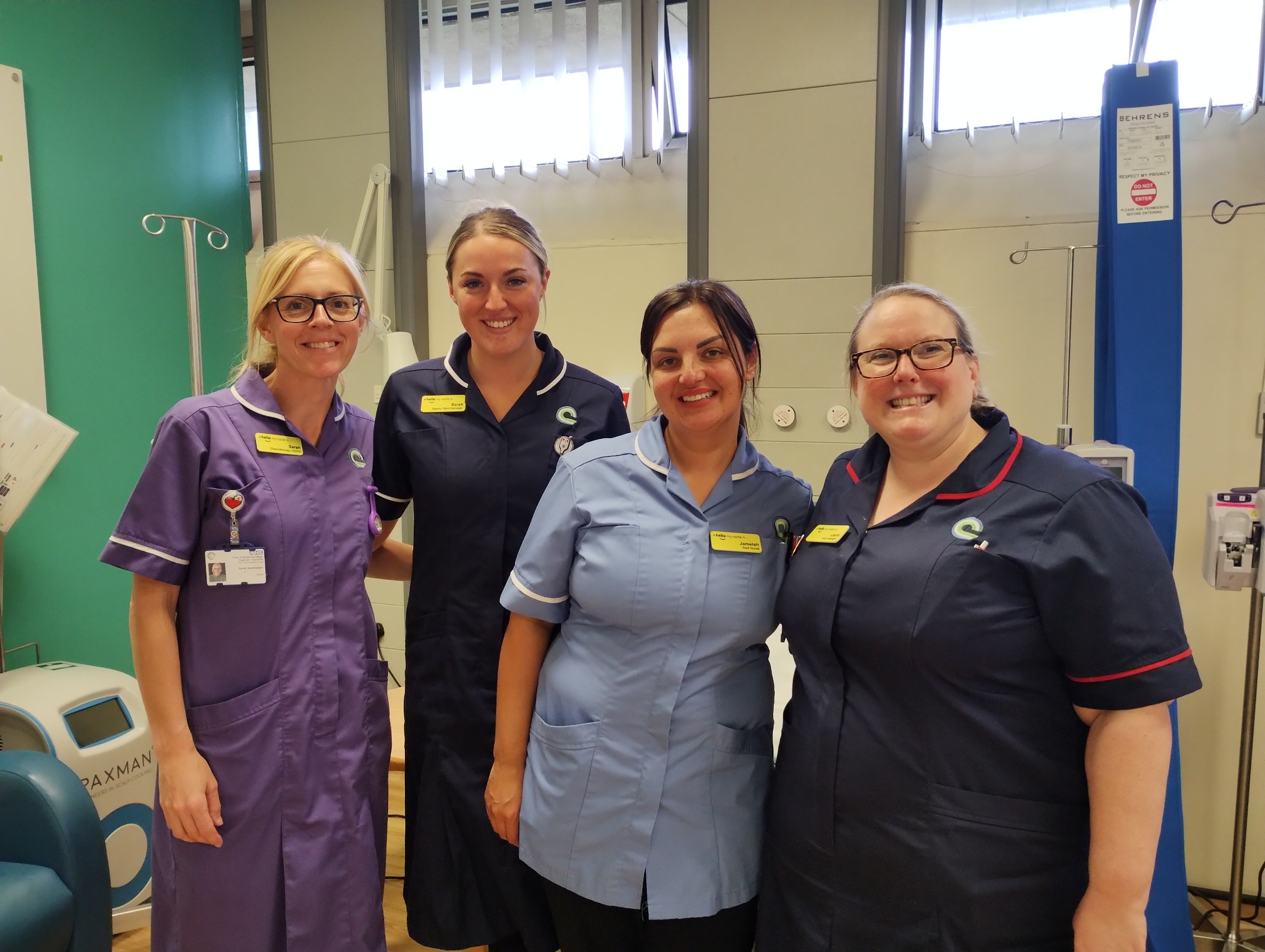 Group of smiling hospital staff in uniform on the treatment unit