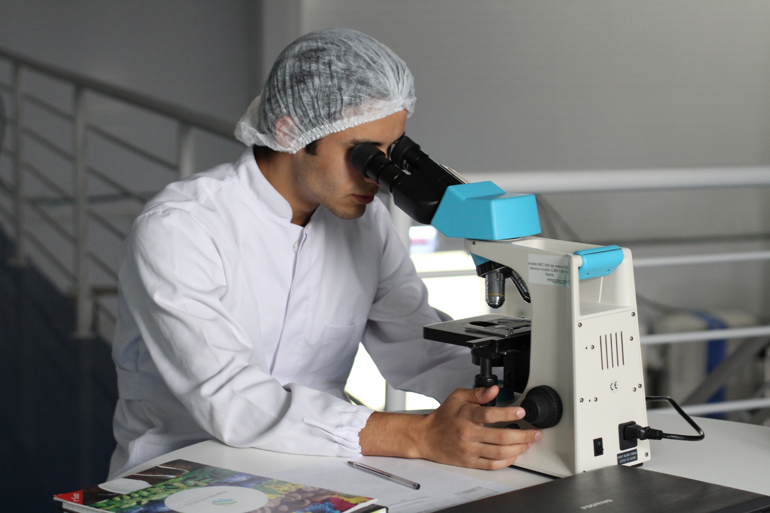 Researcher looking at a microscope