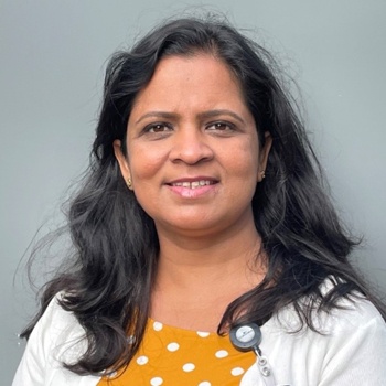 Dr Mehta has wavy shoulder length dark hair