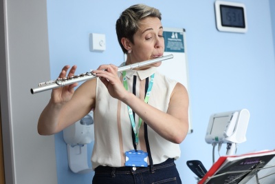 Woman playing flute on hospital ward