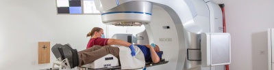 Staff member adjusting male patient on linac.jpg