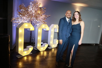 Staff at the 2023 staff excellence awards, standing by illuminated CCC sign