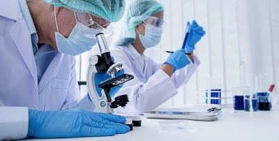 Two researchers working with lab equipment