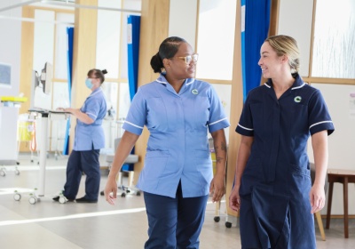 Chemo staff - CCC-Liverpool - black nurse and white nurse walking