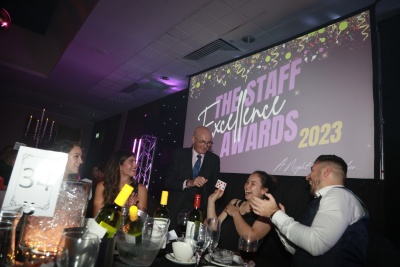 Staff sitting around a dinner table at the awards ceremony