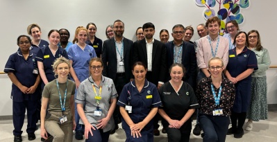 Large group shot of CAR-T team members including doctors, nurses and others. They are standing on Level 5 of the hospital, outside the CAR-T and stem cell unit